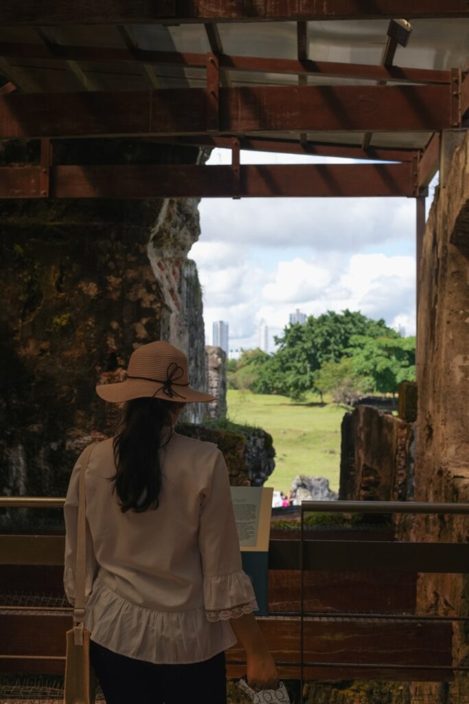 Woman reading a plaque inside convent ruins in Panama Viejo museum