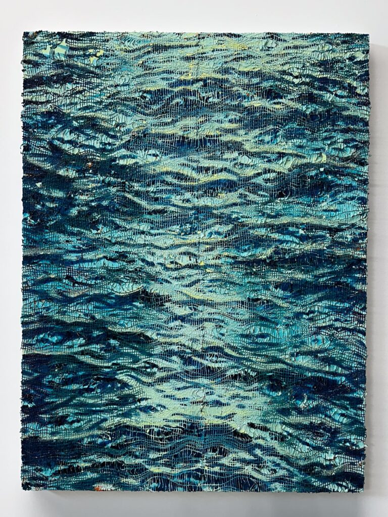 Painting of ocean waves painted over a fisherman net inside an art gallery in Panama City