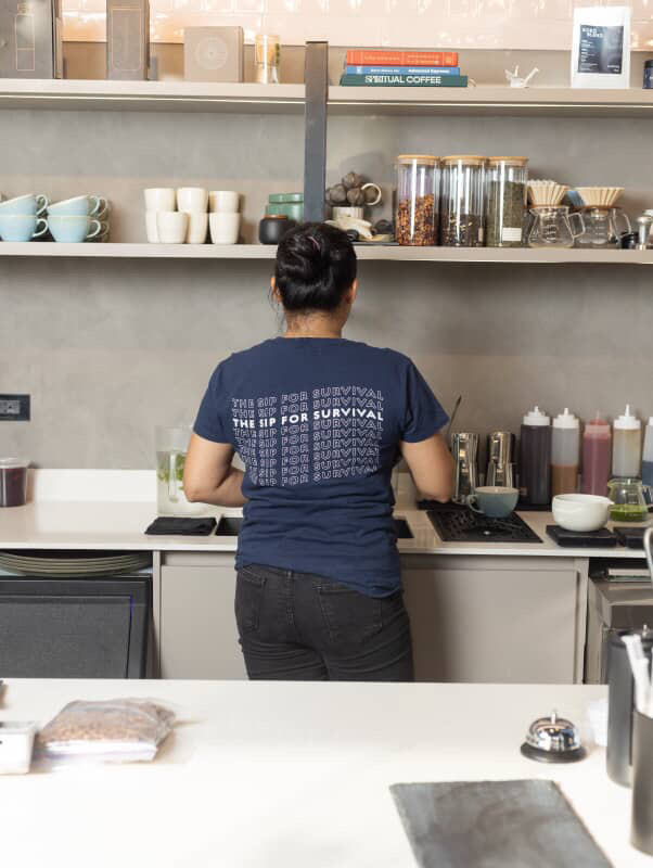 lady making an order behind the pass in kokoma cafe