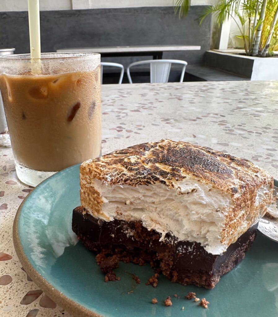 Bitten dessert and coffee in a cafe