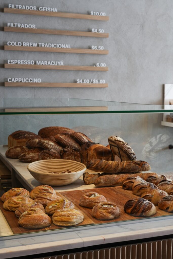 display of cardamom buns and bread inside a cafe in panama city