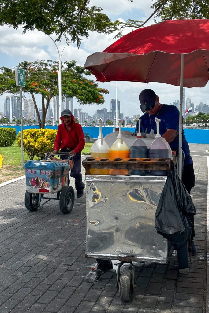 Shaved ice and popsicle vendors side by side on Cinta Costera