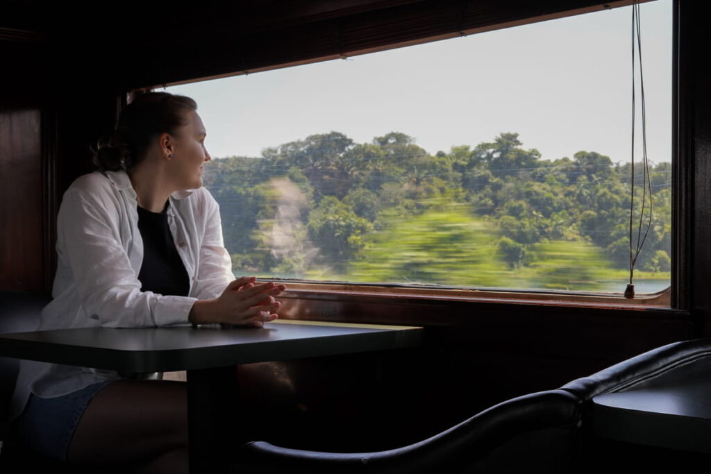 girl looking at the view out of the window of panama canal train on a day trip