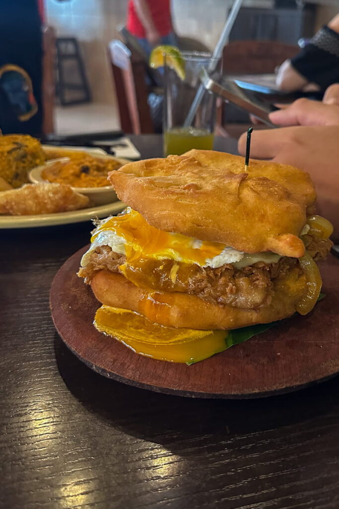 sandwich el patriota held together by hojaldra fried dough inside tranditional panamanian restaurant